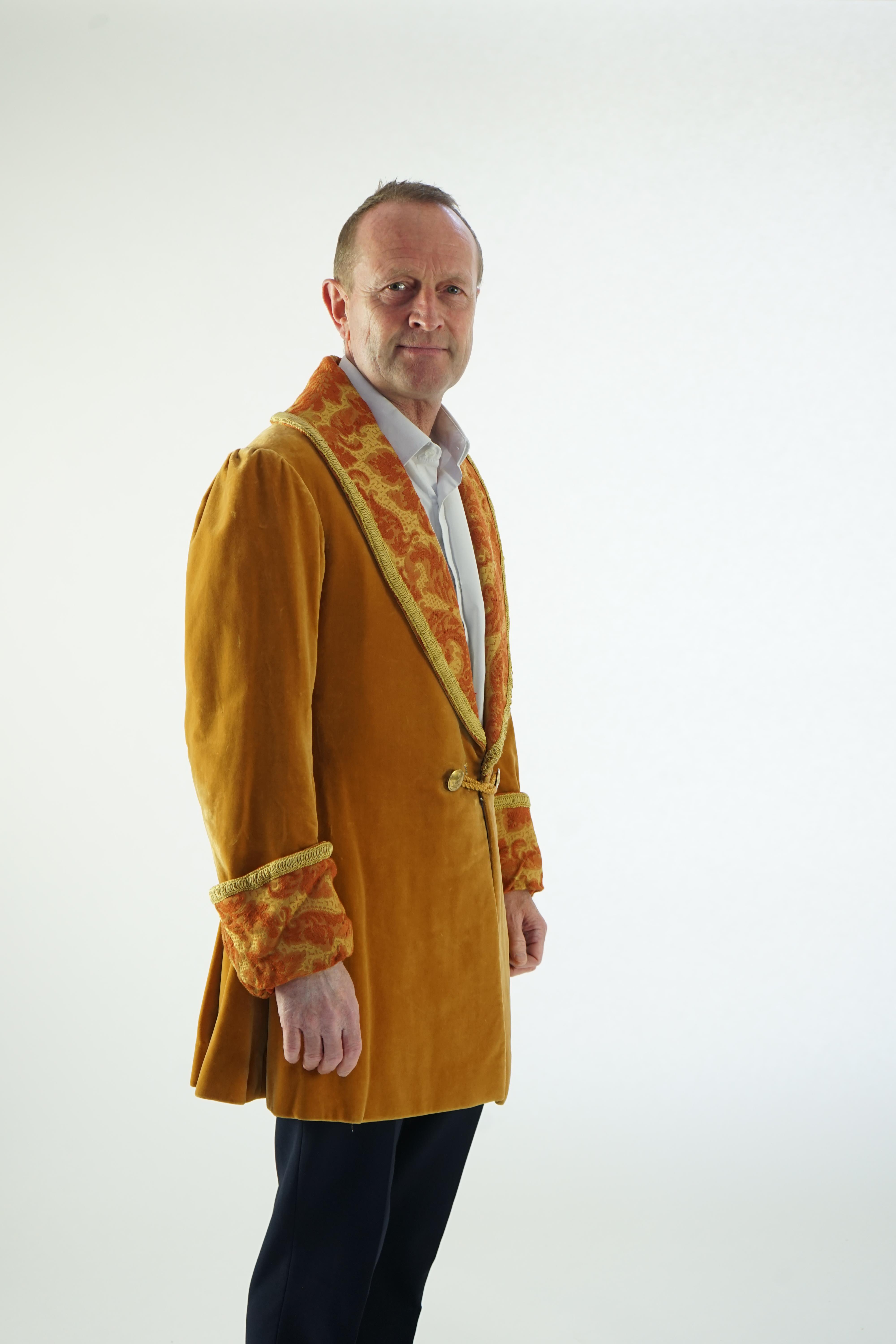 A man's 19th century smoking jacket, mustard velvet, with brocade lapels and cuffs. Ex Royal Opera House 'Arabella'